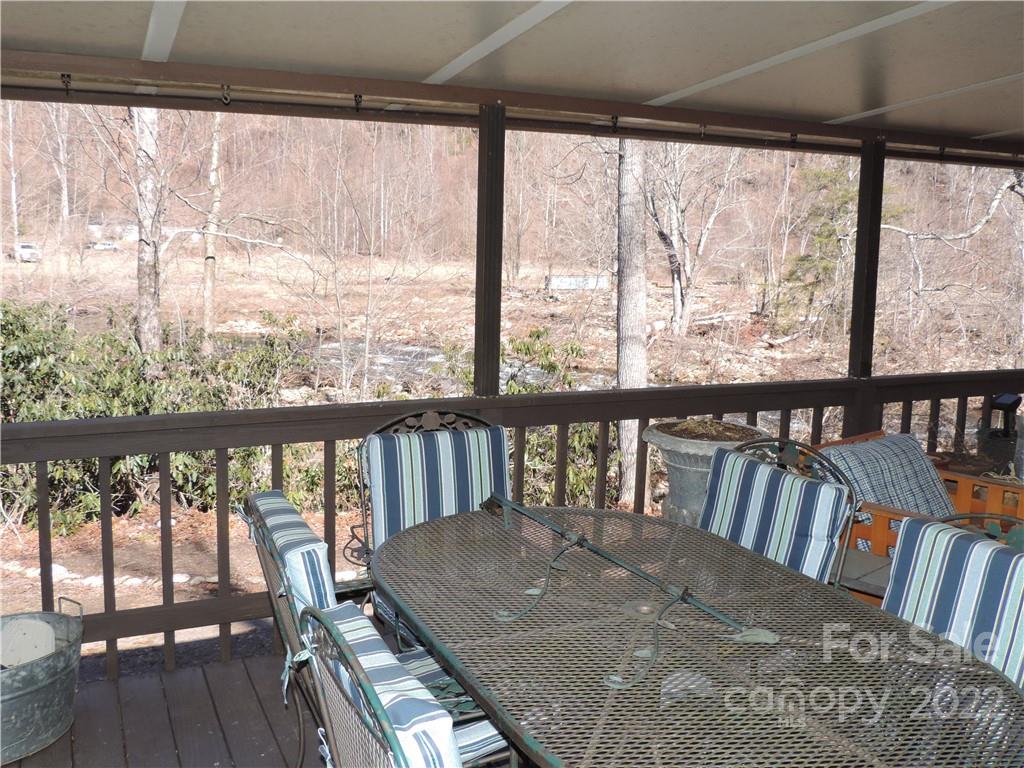 3284 Lake Logan Road Canton, NC 28716 - Photo 28 of 44 a view of a balcony with furniture and wooden floor