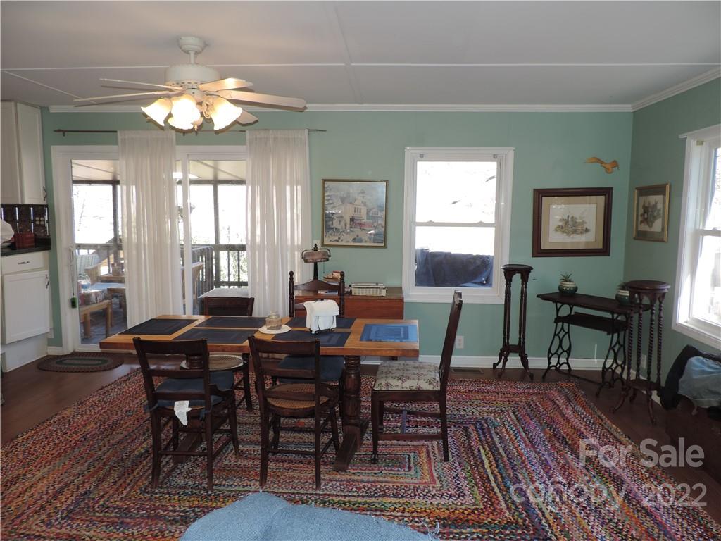 3284 Lake Logan Road Canton, NC 28716 - Photo 3 of 44 a view of a dining room with furniture window and wooden floor