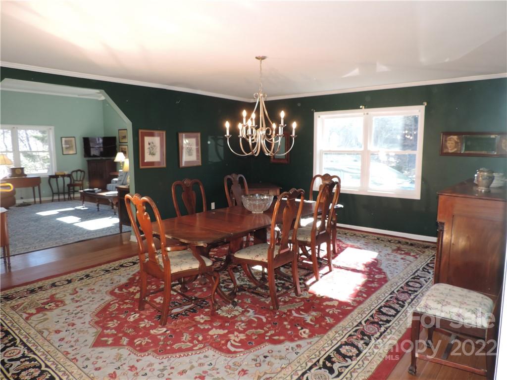 3284 Lake Logan Road Canton, NC 28716 - Photo 7 of 44 a view of a dining room with furniture window and wooden floor