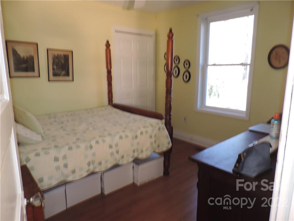 3284 Lake Logan Road Canton, NC 28716 - Photo 9 of 44 a bedroom with a bed and a table in it