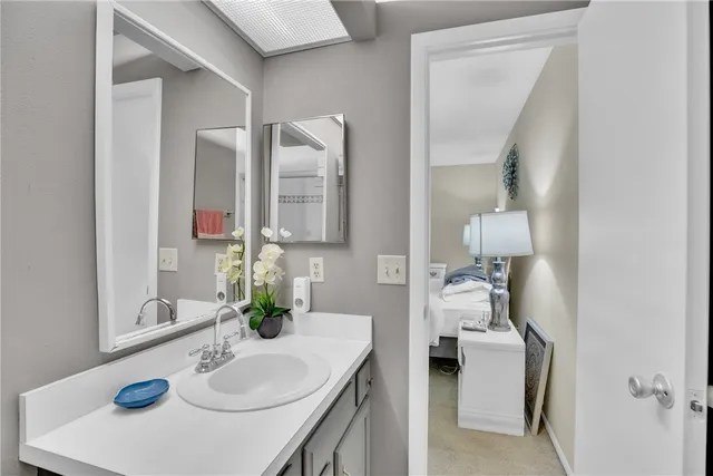 a bathroom with a sink vanity and mirror