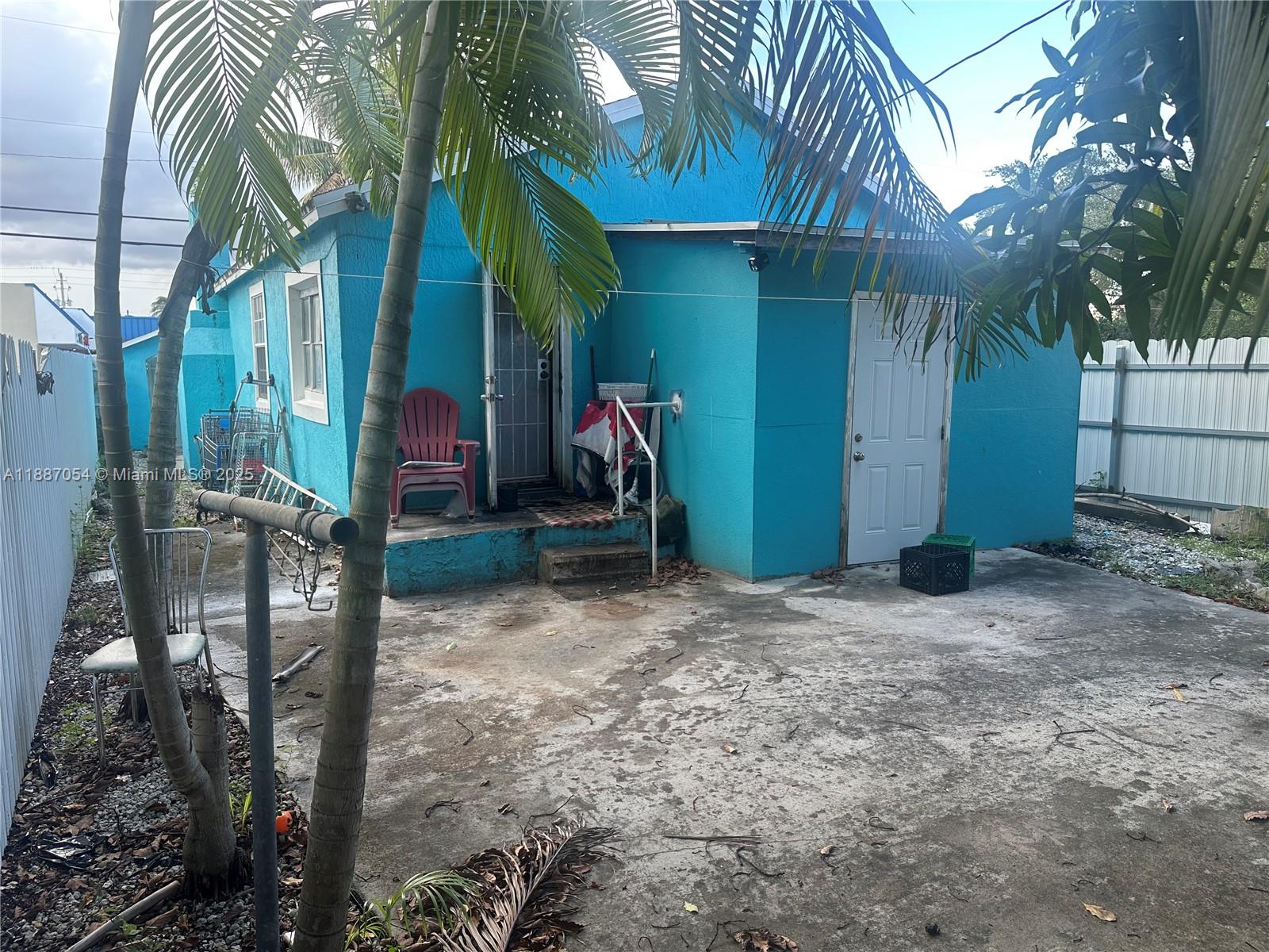 390 Northeast 166th Street Miami, FL 33162 - Photo 4 of 10 a view of a house with basketball court