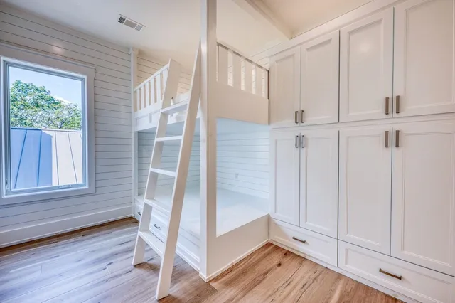 a view of a hallway with wooden floor and entryway