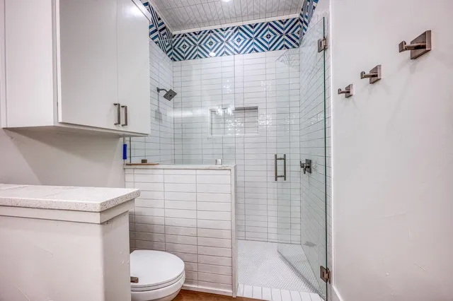 a bathroom with a toilet a sink and shower