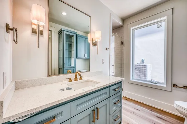 a bathroom with a shower sink and mirror