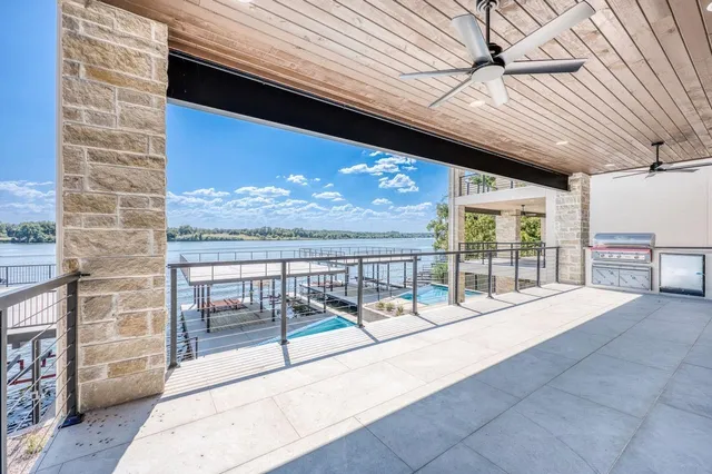 a view of a balcony with floor to ceiling windows with wooden floor