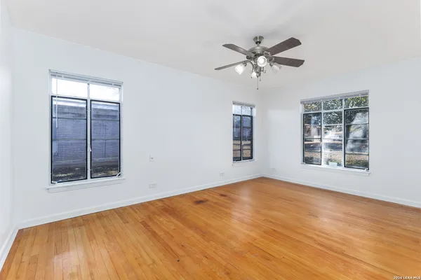 a view of an empty room with a window and closet area
