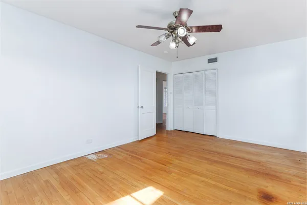 a view of a big room with a ceiling fan