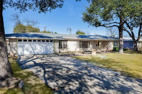 a view of a house with a backyard and a patio