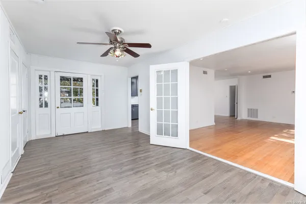 wooden floor in an empty room with a window
