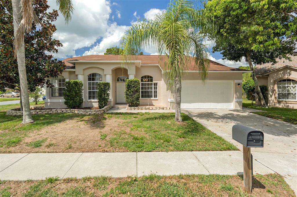12031 Penzance Lane New Port Richey, FL 34654 - Photo 1 of 1 a front view of a house with garden