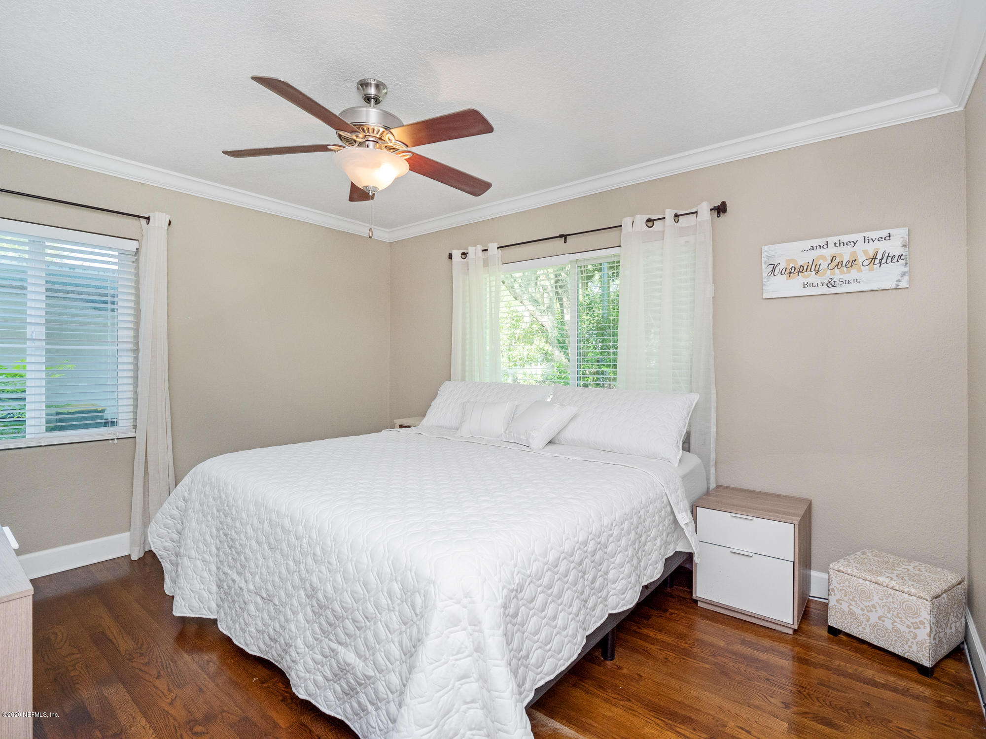 6319 Wesleyan Road Jacksonville, FL 32217 - Photo 14 of 24 a bedroom with a bed and wooden floor