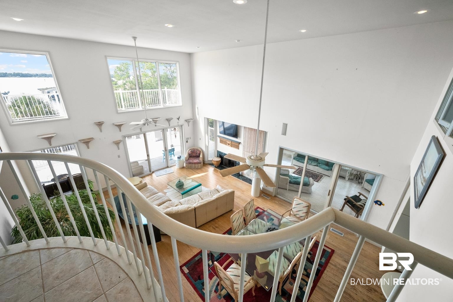 29255 Ono Boulevard Orange Beach, AL 36561 - Photo 31 of 43 Living room featuring a high ceiling, wood finished floors, recessed lighting, a ceiling fan, and stairway