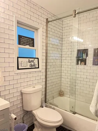 a bathroom with a toilet and shower