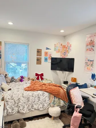 a bedroom with a bed and flat screen tv