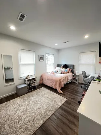 a bedroom with bed and window