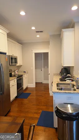 a kitchen with stainless steel appliances granite countertop a stove a refrigerator and a microwave