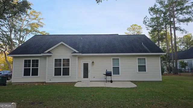 a front view of a house with a garden and yard