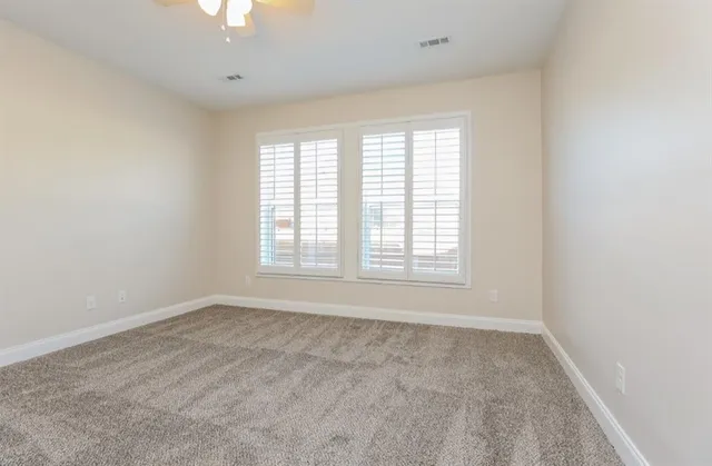 an empty room with a empty space and a window