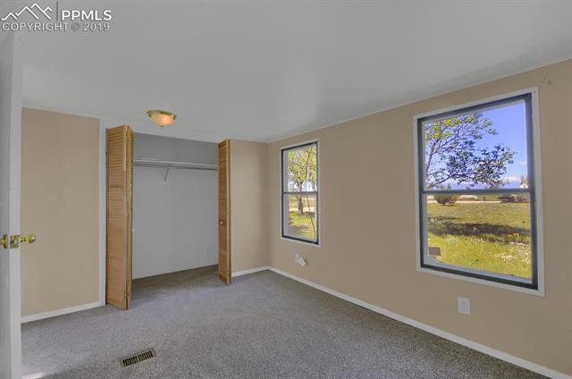 5645 Good Fortune Road Peyton, CO 80831 - Photo 13 of 23 Bedroom 1 has views of the mountains.
