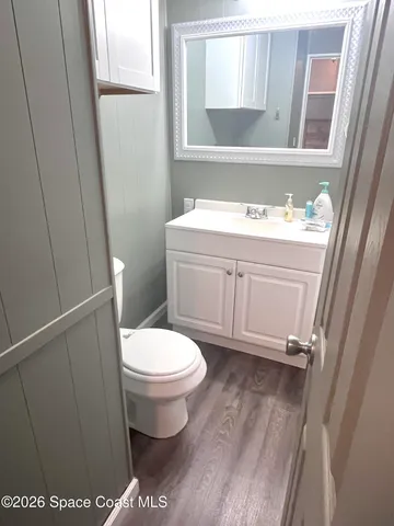 a bathroom with a sink a toilet and a window