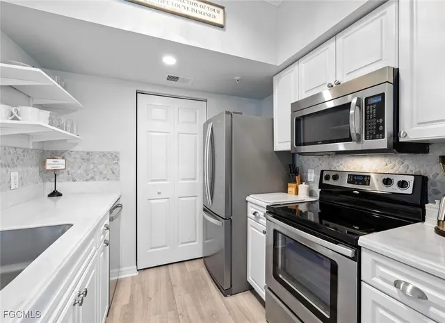 a kitchen with a sink stove and refrigerator