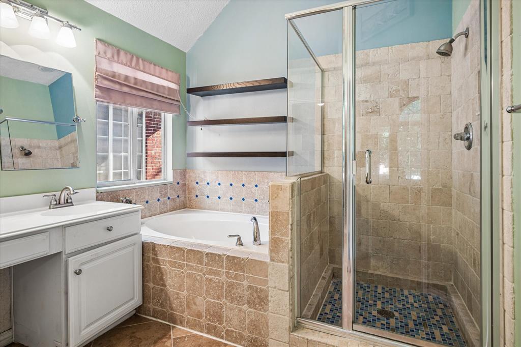 14592 Greenleaf Court Addison, TX 75001 - Photo 20 of 34 Full bathroom with vanity, a stall shower, a garden tub, and tile patterned floors