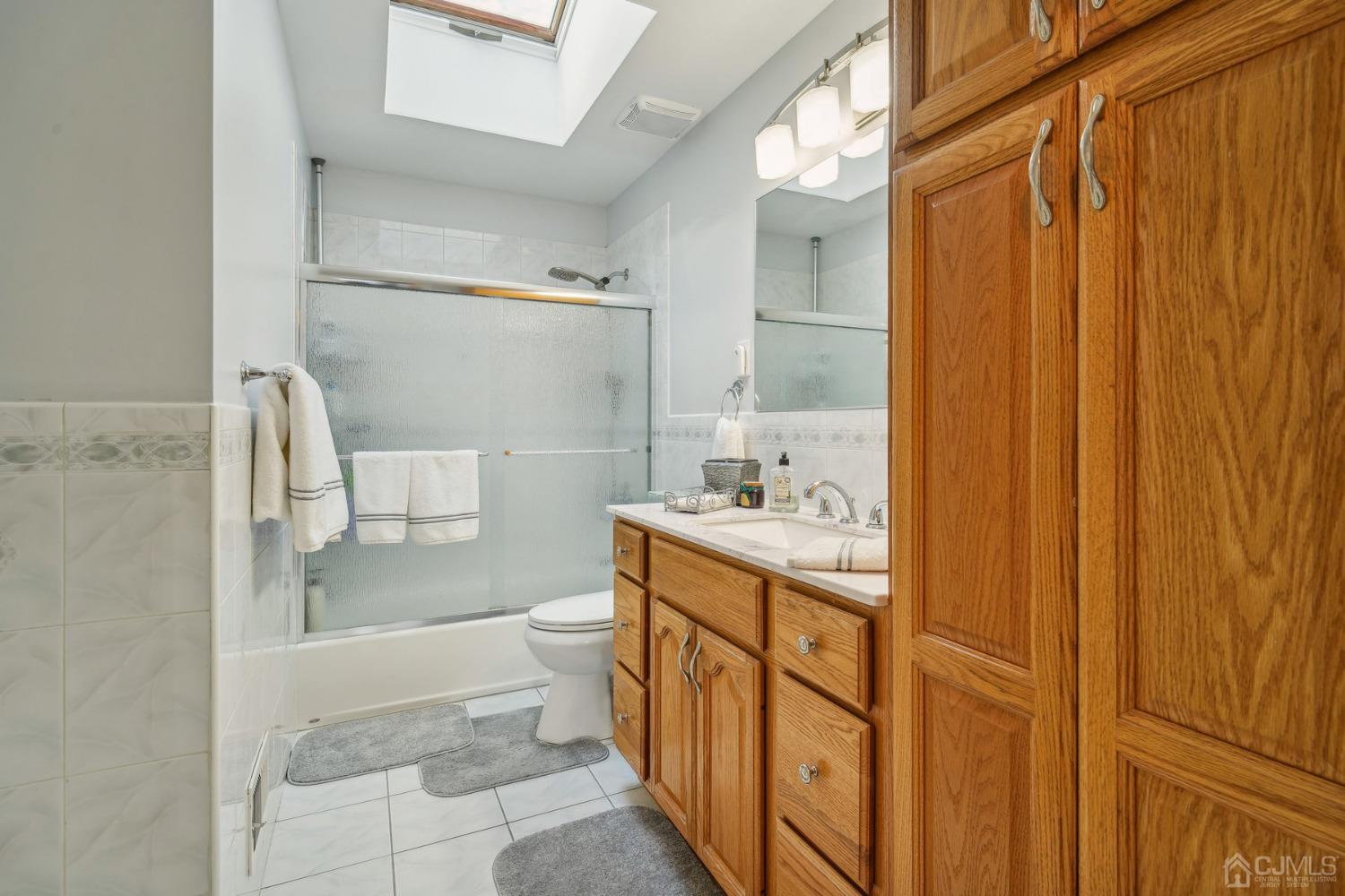 418 Durham Avenue Edison, NJ 08817 - Photo 11 of 30 a bathroom with a granite countertop sink and a mirror