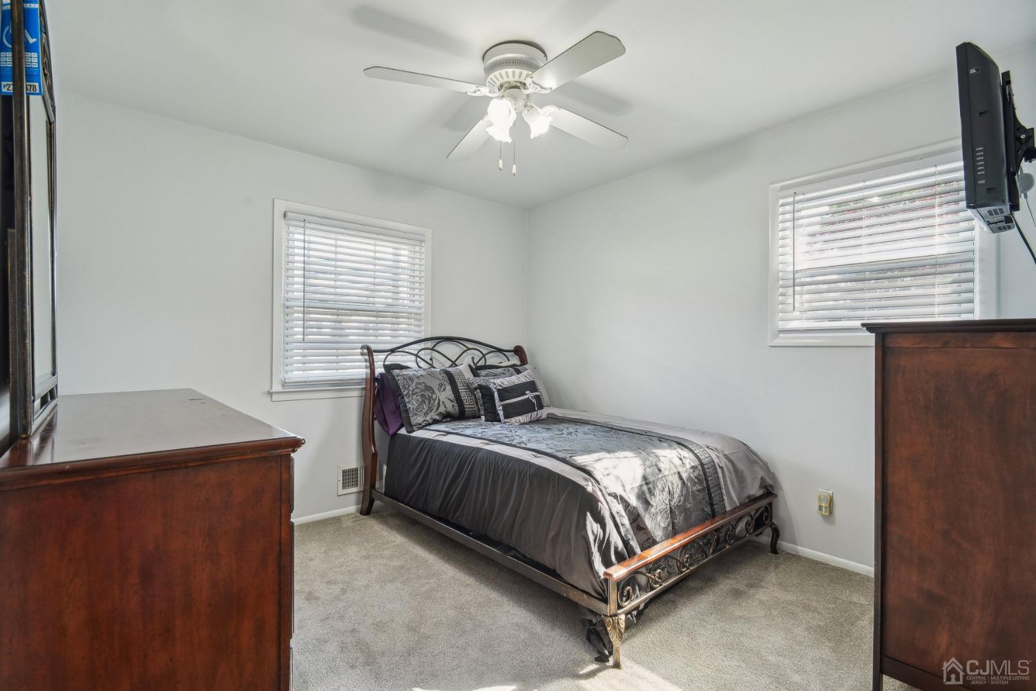 418 Durham Avenue Edison, NJ 08817 - Photo 14 of 30 a bedroom with a bed and a chandelier