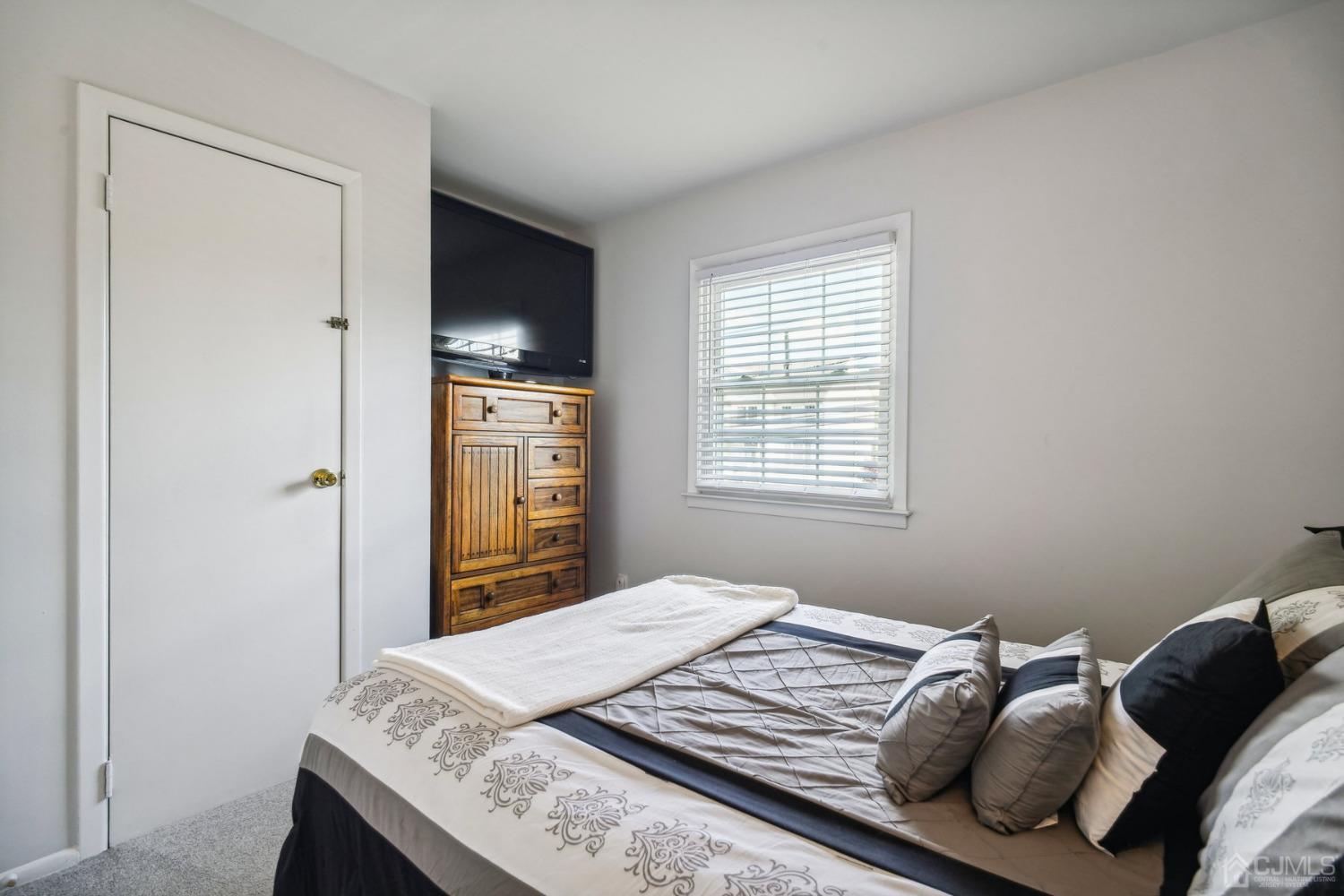 418 Durham Avenue Edison, NJ 08817 - Photo 15 of 30 a bedroom with a bed and a tv