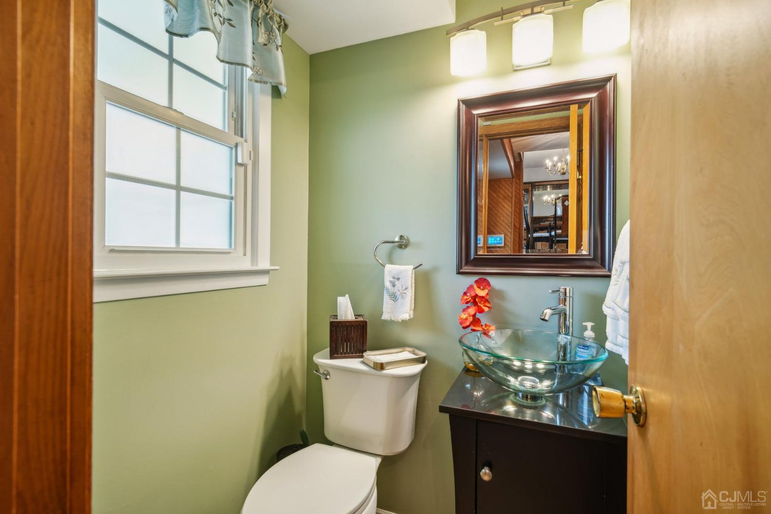 418 Durham Avenue Edison, NJ 08817 - Photo 5 of 30 a bathroom with a toilet sink and mirror