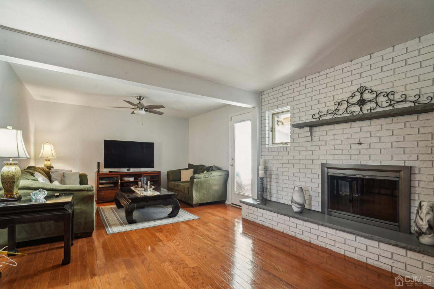 418 Durham Avenue Edison, NJ 08817 - Photo 6 of 30 a living room with furniture a fireplace and a flat screen tv