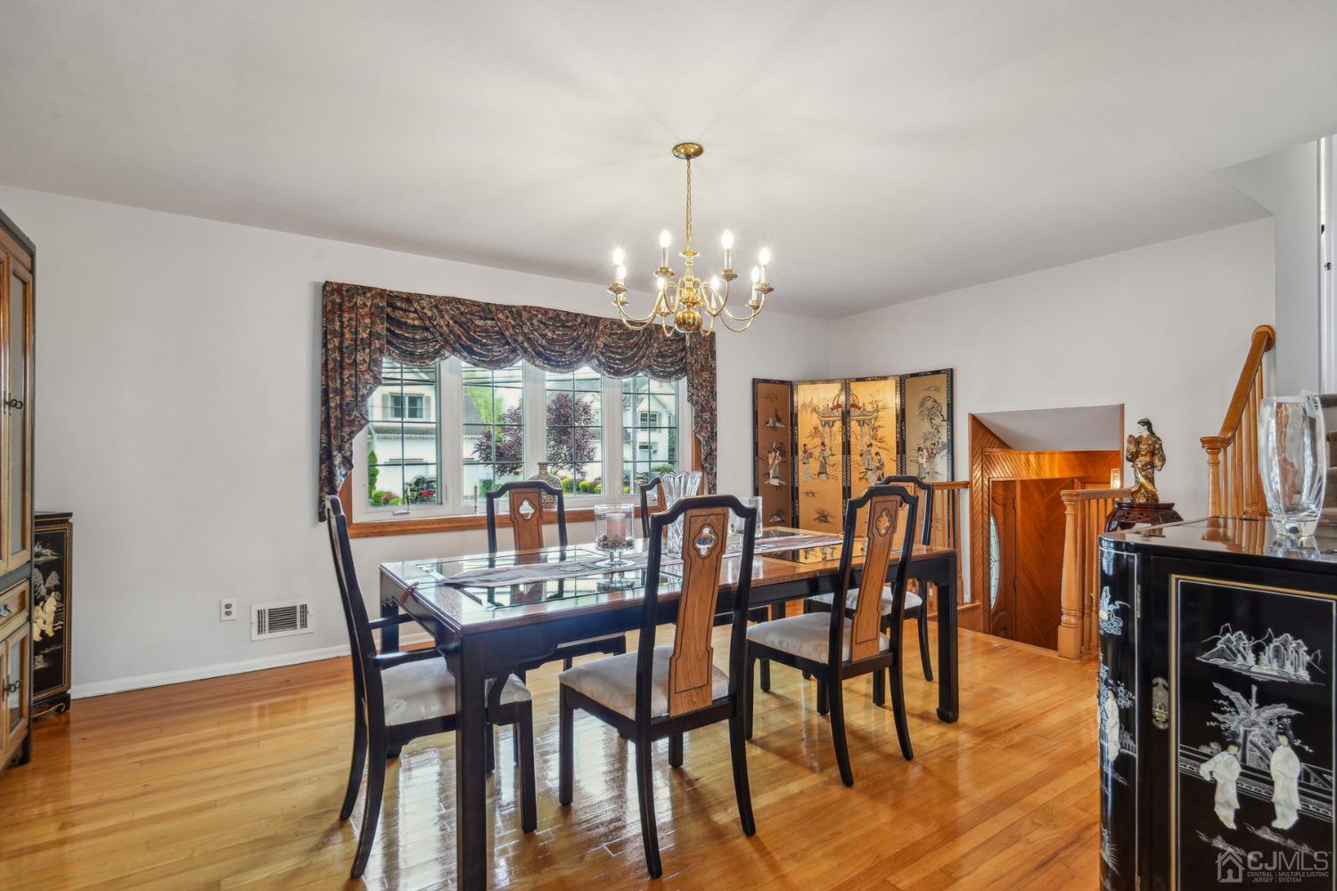 418 Durham Avenue Edison, NJ 08817 - Photo 8 of 30 a dining room with furniture a chandelier and wooden floor