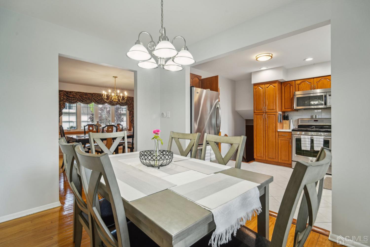 418 Durham Avenue Edison, NJ 08817 - Photo 9 of 30 a view of a dining room with furniture a chandelier and wooden floor