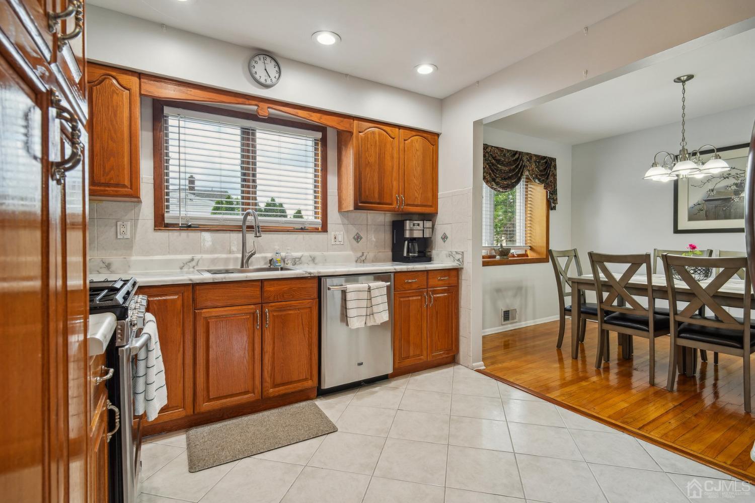 418 Durham Avenue Edison, NJ 08817 - Photo 10 of 30 a kitchen with stainless steel appliances granite countertop sink a window and dining table