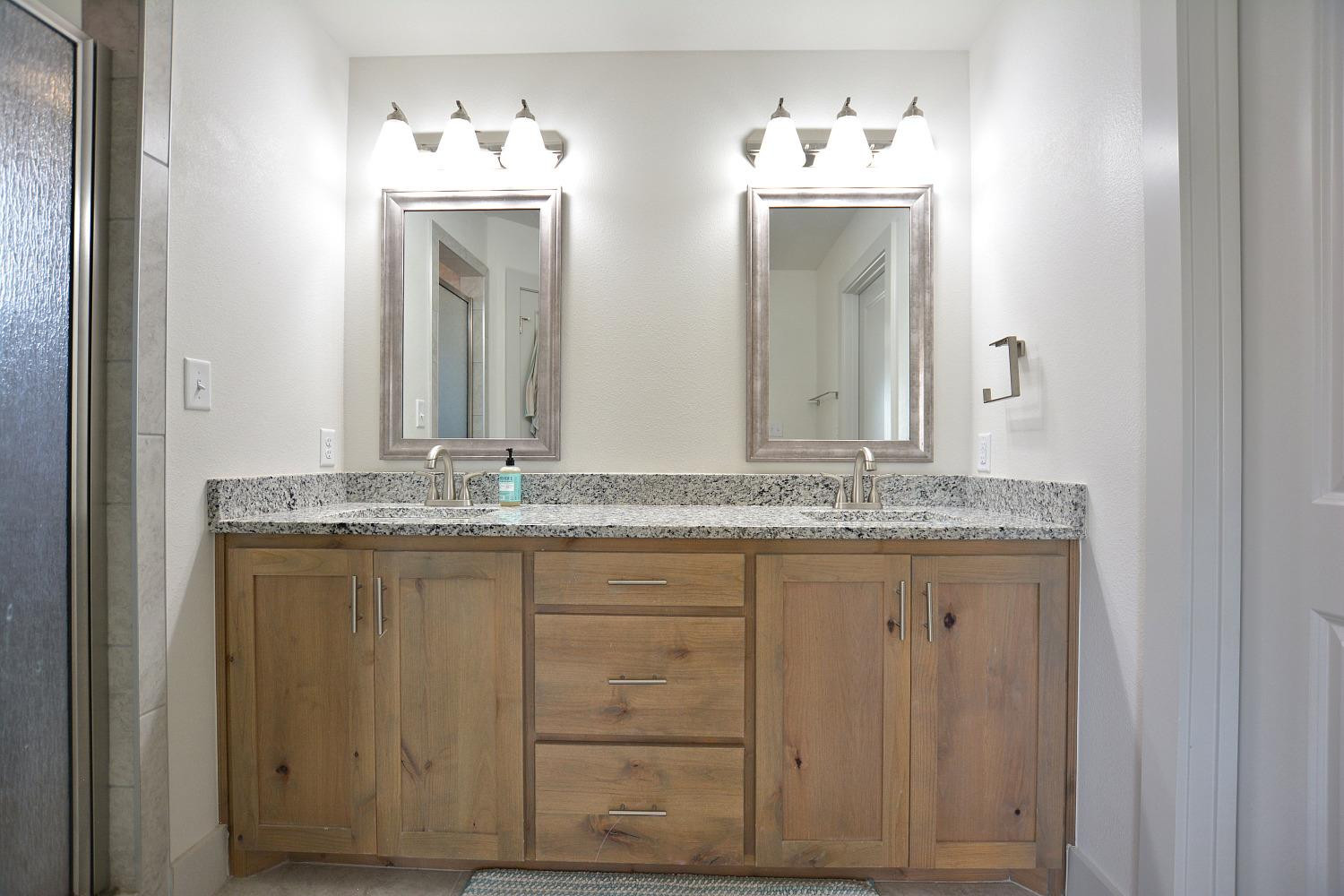 8901 Winfield Avenue Lubbock, TX 79424 - Photo 16 of 22 a bathroom with a granite countertop sink and a mirror