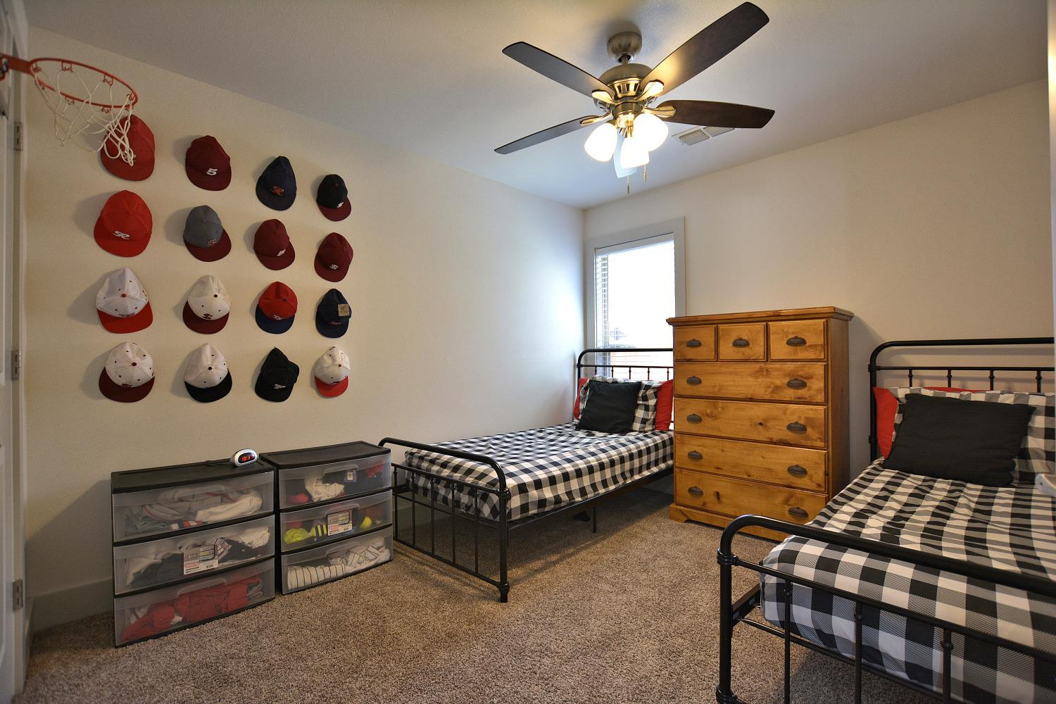 8901 Winfield Avenue Lubbock, TX 79424 - Photo 18 of 22 a bedroom with a bed and a chandelier