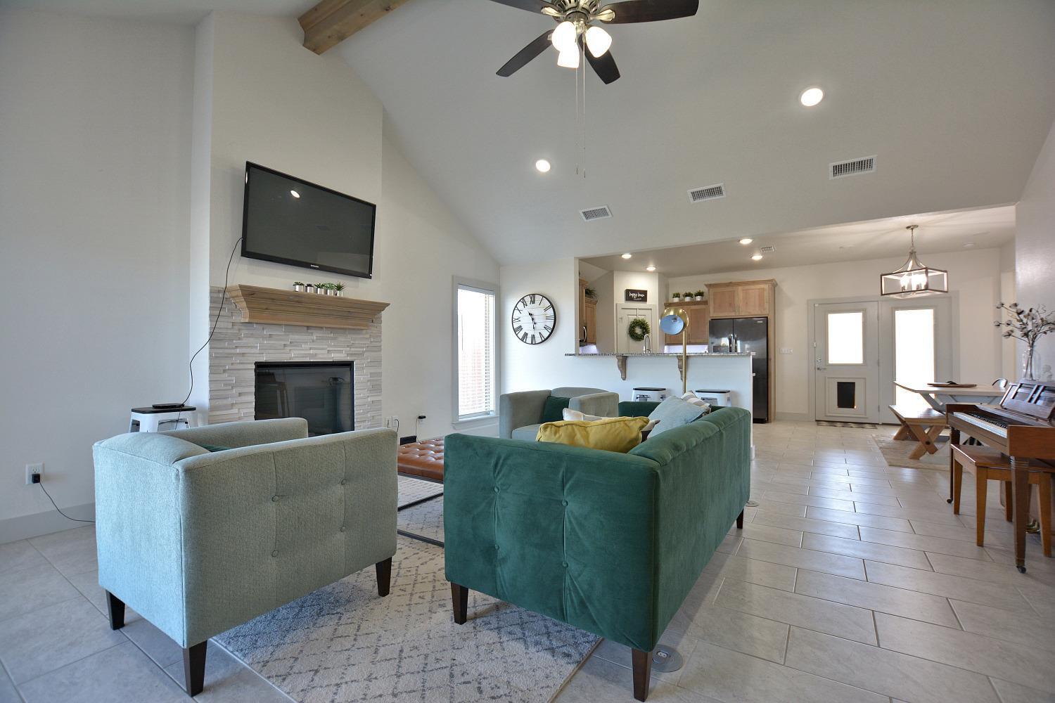 8901 Winfield Avenue Lubbock, TX 79424 - Photo 3 of 22 a living room with furniture a flat screen tv and a fireplace