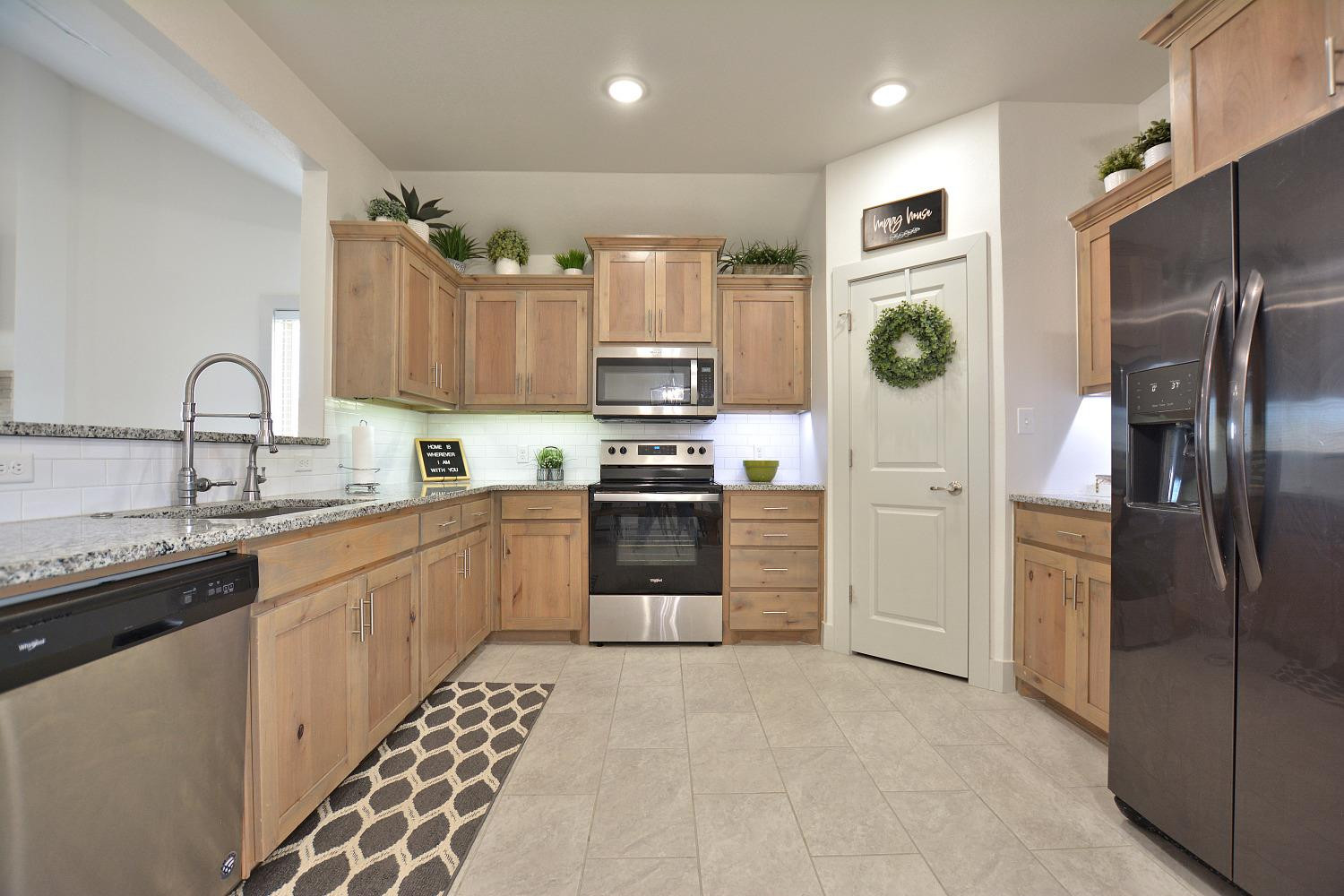 8901 Winfield Avenue Lubbock, TX 79424 - Photo 8 of 22 a kitchen with a sink stainless steel appliances and cabinets