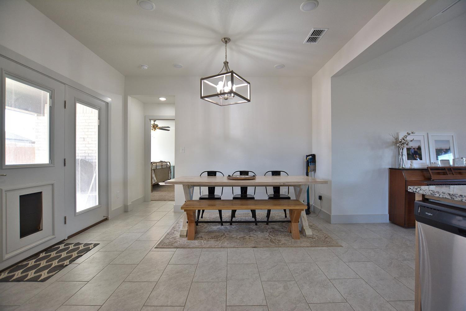 8901 Winfield Avenue Lubbock, TX 79424 - Photo 10 of 22 a view of a dining room with furniture window and wooden floor