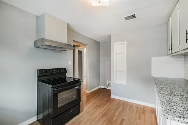 a kitchen with a stove and a refrigerator