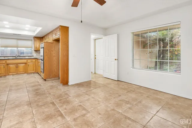 a spacious bathroom with a granite countertop sink and a mirror