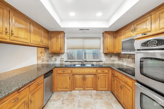 a front view of a house with a yard and fountain