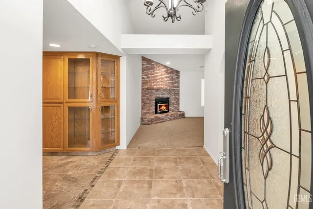 a view of an empty room with a fireplace