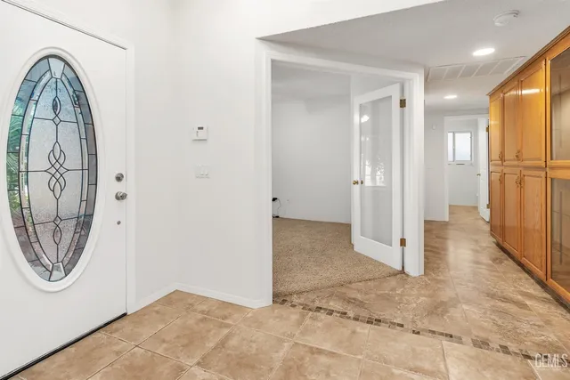 a view of a livingroom with a ceiling fan and window