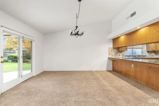 a view of a kitchen with a sink and dishwasher a oven with wooden floor
