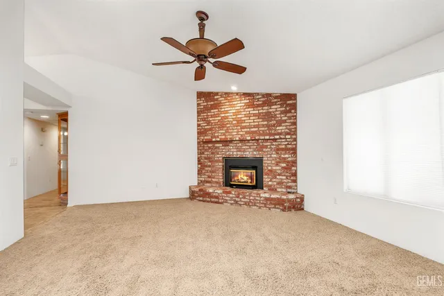 a kitchen with kitchen island granite countertop a sink a stove cabinets and a counter top space