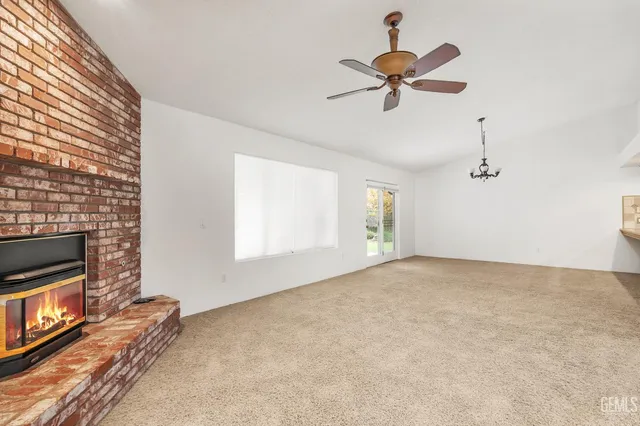 a view of a bedroom with a window and ceiling fan