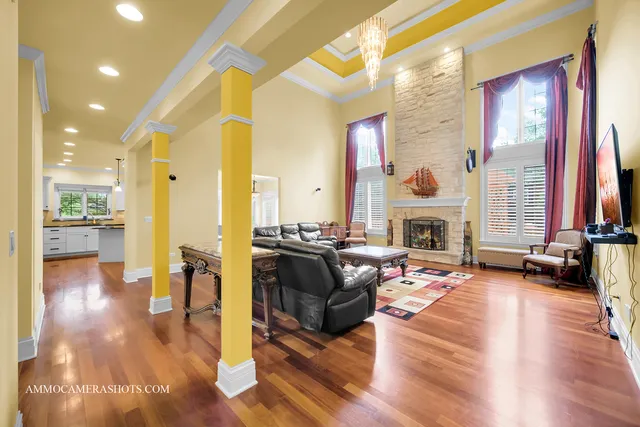 a living room with furniture fireplace and a large window