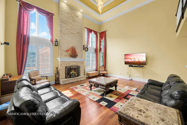 a living room with furniture and floor to ceiling windows